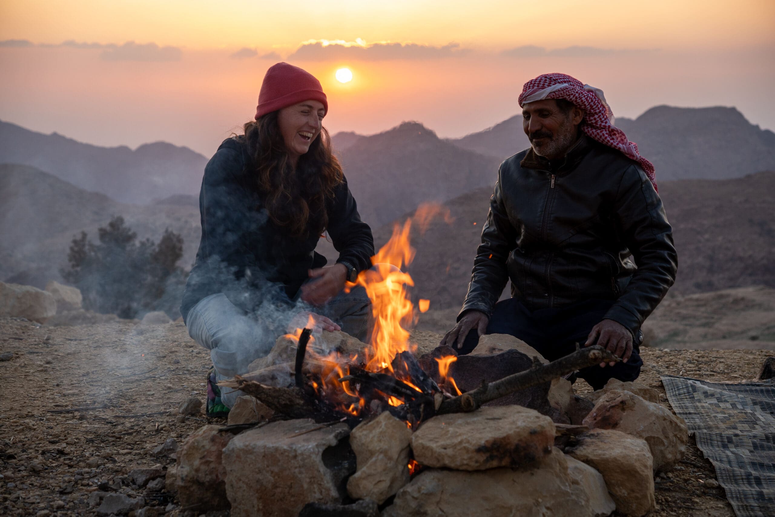 Eid, a Bedouin guide sitting by the fire with Kiera
