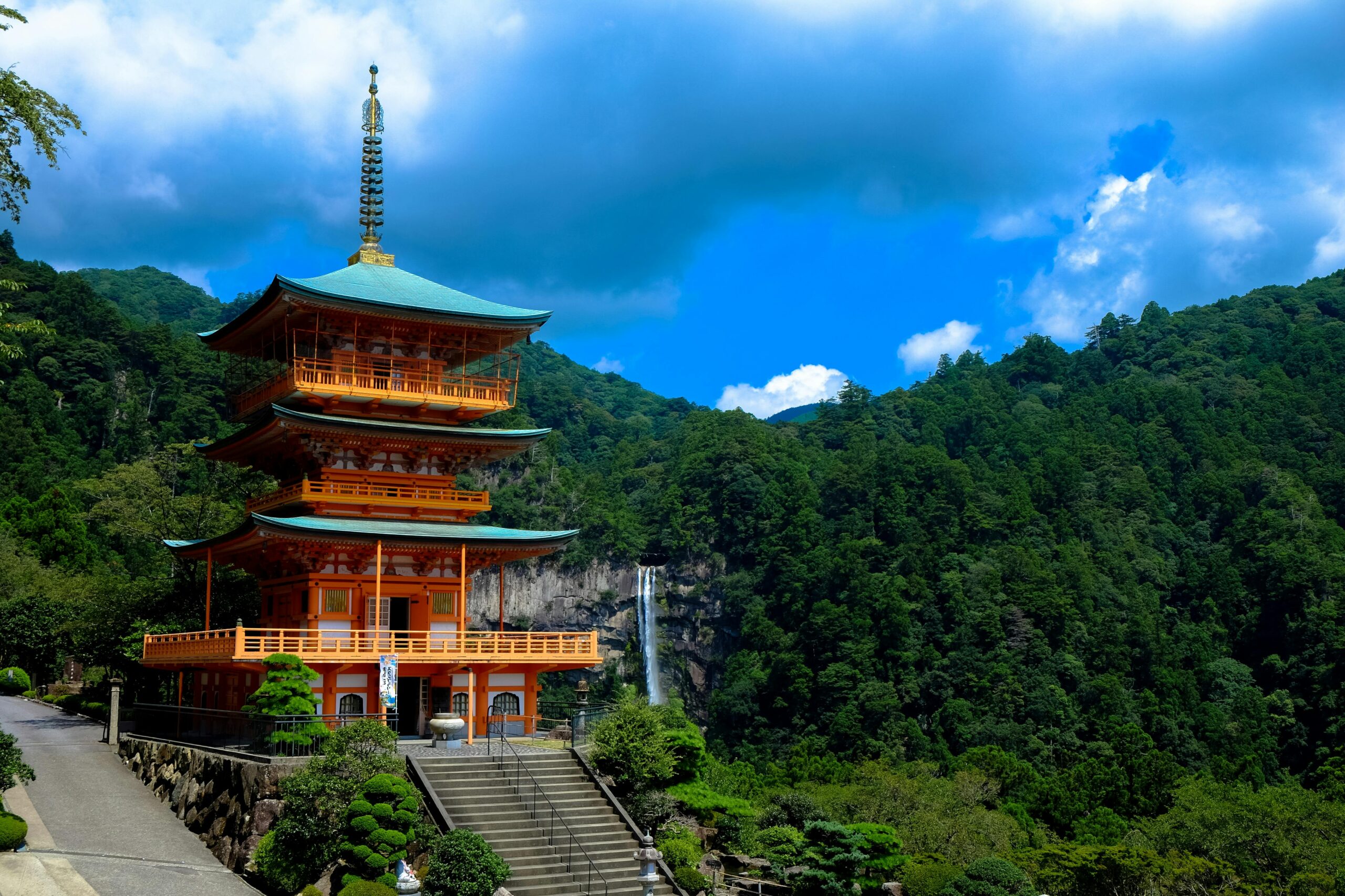 Kumano nachi taisha shrine with waterfalls along in view at season change of Autumn in night time and star on the sky, the famous and popular tourist place in Kumano of Japan